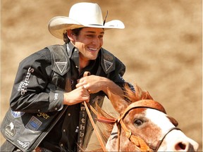 Ty Pozzobon of Merritt, British Colombia, makes the victory lap after taking the day money in the bull riding event during the Calgary Stampede rodeo in Calgary, Alta. on Wednesday July 9, 2014