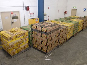 In this undated recent photo provided by the Australian Federal Police, a record haul of 3.9 tonnes of liquid ephedrine sits stored in a warehouse which smugglers shipped to Sydney from Thailand in bottles of iced tea. The AFP said Friday, Oct. 6, 2017, the liquid ephedrine haul was the largest seizure of precursor chemicals at the Australian border, eclipsing the previous record of 1.4 tonnes only four months ago. (Australian Federal Police via AP)