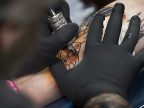When surgeons removed an enlarged node from the woman's armpit, they discovered a collection of immune cells that were filled with dark colouring from a 15-year-old tattoo.
