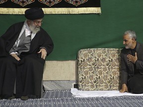 FILE - In this March 27, 2015 file photo released by the official website of the office of the Iranian supreme leader, commander of Iran's Quds Force, Qassem Soleimani, right, greets Supreme Leader Ayatollah Ali Khamenei while attending a religious ceremony in a mosque at his residence in Tehran, Iran. While U.S. President Donald Trump angered Iran with his speech on refusing to re-certify the nuclear deal, Tehran won't walk away from it in retaliation. (Office of the Iranian Supreme Leader via AP, File)
