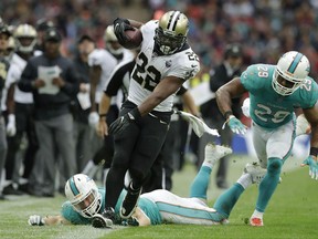 New Orleans Saints running back Mark Ingram (22) runs against the Miami Dolphins during the second half of an NFL football game at Wembley Stadium in London, Sunday Oct. 1, 2017. (AP Photo/Matt Dunham)