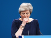 British PM Theresa May struggles with a cough during her speech.