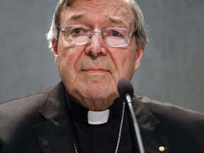 FILE - In this June 29, 2017 file photo, Cardinal George Pell meets the media, at the Vatican. Cardinal George Pell, the most senior Catholic official to face sex offense charges, was jeered by protesters as he made a court appearance on Friday, Oct. 6, 2017 in his native Australia. (AP Photo/Gregorio Borgia, File)