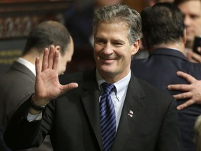 FILE - In this Jan. 8, 2015 file photo, former Massachusetts Sen. Scott Brown greets people on the floor of the House Chamber at the Statehouse in Boston.  U.S. Ambassador to New Zealand Brown told a New Zealand website Wednesday, Oct. 25, 2017, he accepted advice that he should be more culturally aware after a U.S. inquiry into his conduct at a Peace Corps event in Samoa. The Stuff news outlet says Brown acknowledged complaints were made about his comments to a female food server at the event and to guests upon his arrival in the Pacific country in July. (AP Photo/Steven Senne, File)