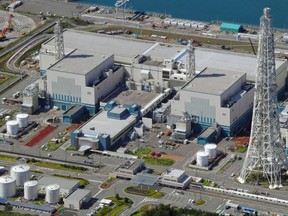 This Sept. 30, 2017 aerial photo shows the reactors of No. 6, right, and No. 7, left, at Kashiwazaki-Kariwa nuclear power plant, Niigata prefecture.  Japanese nuclear regulators say two reactors run by the utility blamed in the Fukushima plant meltdowns have met their safety standards, saying the operator has since taken sufficient measures at another plant it owns.  The Nuclear Regulation Authority unanimously approved Wednesday, Oct. 4, 2017,  a draft certificate for No. 6 and No. 7 reactors at the plant in northern Japan operated by the Tokyo Electric Power Co. under stricter standards set after the 2011 Fukushima disaster.  (Kyodo News via AP)