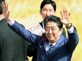 Japanese Prime Minister and leader of ruling Liberal Democratic Party Shinzo Abe waves to the crowd, during his party's election campaign in Fukushima, eastern Japan, Tuesday, Oct. 10, 2017.