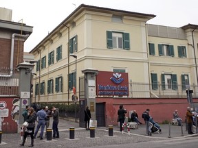 FILE - This April 1, 2016, file photo shows a view of the Bambino Gesu' pediatric hospital in Rome. The Vatican trial over $500,000 in donations to the pope's pediatric hospital that were diverted to renovate a cardinal's penthouse is reaching its conclusion, with neither the cardinal who benefited nor the contractor who was apparently paid twice for the work facing trial. Instead, the former president of the Bambino Gesu children's hospital and his ex-treasurer are accused of misappropriating 422,000 euros from the hospital's fundraising foundation to overhaul the retirement home of Cardinal Tarcisio Bertone, the Vatican secretary of state under Pope Benedict XVI. (AP Photo/Andrew Medichini)