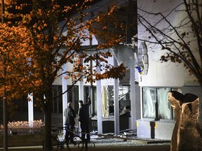 Police forensics work at the scene after a powerful explosion at the main entrance to a police station in Helsingborg, Sweden, Wednesday, Oct. 18, 2017. Swedish authorities said the explosion caused significant damage to the building. There have been no injuries and nobody has been arrested. (Johan Nilsson via TT News Agency via AP)