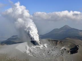 Volcanic smoke rises from the Shinmoedake volcano after its eruption in the border of Kagoshima and Miyazaki prefectures, southwestern Japan, Thursday, Oct. 12, 2017. The volcano erupted Thursday for the first time in six years and spread ash in nearby cities and towns. (Tomoaki Ito/Kyodo News via AP)