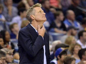 Golden State Warriors coach Steve Kerr stands on the sideline during the first half of the team's NBA basketball game against the Memphis Grizzlies on Saturday, Oct. 21, 2017, in Memphis, Tenn. (AP Photo/Brandon Dill)