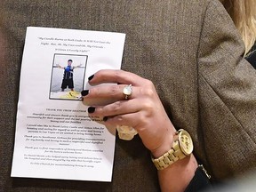 Kelsey Paris becomes emotional as she embraces her grandfather and Sonny Melton's father, James Warren Melton, Monday, Oct. 9, 2017, during Sonny's visitation at Big Sandy High School in Big Sandy, Tenn. Sonny was killed during a mass shooting at a country music festival in Las Vegas. (Morgan Timms/The Jackson Sun via AP)