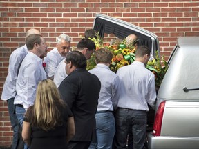 Sonny Melton's casket is loaded into a hearse after his funeral at Big Sandy High School, Tuesday, Oct. 10, 2017,  in Big Sandy, Tenn. Melton, a registered nurse, died protecting his wife during the Las Vegas shooting massacre.  (Morgan Timms /The Jackson Sun via AP)