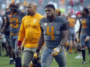 FILE - In this Sept. 30, 2017, file photo, Tennessee running back John Kelly (4) walks off the field after their 41-0 loss to Georgia in an NCAA college football game in Knoxville, Tenn. Kelly and linebacker Will Ignont have received citations after police said they found marijuana in Kelly's car during a traffic stop. Knoxville police say they stopped a car for having a headlight out Tuesday, Oct. 24, 2017, at about 10:46 p.m. Police said they searched the vehicle after smelling marijuana and found 4.6 grams of marijuana and a glass pipe in the console. (Caitie McMekin/Knoxville News Sentinel via AP, File)