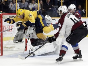 Nashville Predators center Colton Sissons (10) collides with Colorado Avalanche goalie Semyon Varlamov, of Russia, as Sissons scores a goal in the second period of an NHL hockey game Tuesday, Oct. 17, 2017, in Nashville, Tenn. (AP Photo/Mark Humphrey)