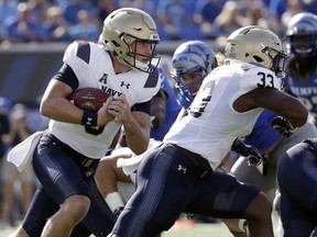 Navy quarterback Zach Abey, left, runs the ball behind the blocking of fullback Chris High (33) in the first half of an NCAA college football game against Memphis Saturday, Oct. 14, 2017, in Memphis, Tenn. (AP Photo/Mark Humphrey)