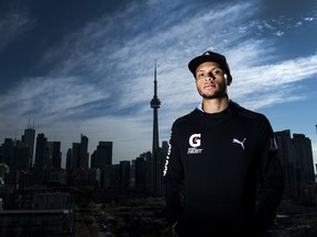 Canadian track and field star Andre De Grasse poses for a photograph after Athletics Canada held a news conference to announce the Track and Field in the 6ix event in Toronto on Thursday, Oct. 19, 2017.