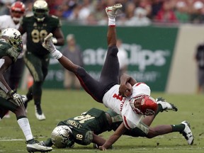 Houston quarterback D'Eriq King (4) is upended by South Florida safety Jaymon Thomas (18) during the first half of an NCAA college football game Saturday, Oct. 28, 2017, in Tampa, Fla. (AP Photo/Chris O'Meara)