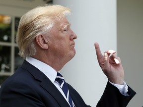 President Donald Trump prepares to call choose a reporter to call on for a question during a media availability in the Rose Garden with Senate Majority Leader Mitch McConnell of Ky., after their meeting at the White House, Monday, Oct. 16, 2017, in Washington.