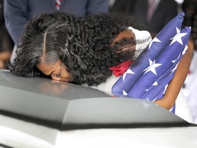 Myeshia Johnson, the wife of Army Sgt. La David Johnson, kisses her husband's casket during the funeral service at the Hollywood Memorial Gardens in Hollywood, Fla.