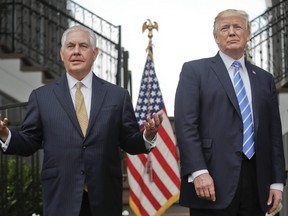Secretary of State Rex Tillerson, left, speaks following a meeting with President Donald Trump at Trump National Golf Club in Bedminster, N.J. Trump challenged Tillerson to compare IQ tests, delivering a sharp-edged ribbing that threw a bright spotlight on his seemingly shaky relationship with his top diplomat. The White House insisted he was only joking.