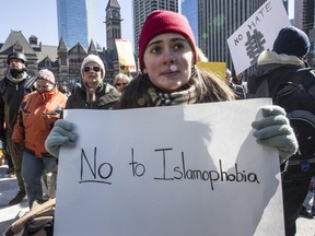 A woman and other demonstrators protest Islamophobia at City Hall in Toronto, Ont. on Saturday March 4, 2017.