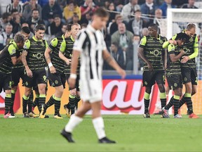Sporting Lisbon players celebrate after Juventus' Alex Sandro scored an own goal, during the Champions League group D soccer match between Juventus and Sporting, at the Allianz stadium in Turin, Italy, Wednesday, Oct. 18, 2017. (Alessandro Di Marco/ANSA via AP)