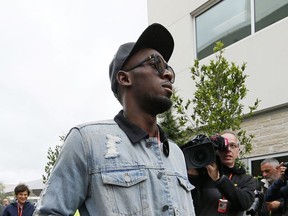 Usain Bolt walks through the garage area before the Formula One U.S. Grand Prix auto race at the Circuit of the Americas, Sunday, Oct. 22, 2017, in Austin, Texas. (AP Photo/Tony Gutierrez, Pool)