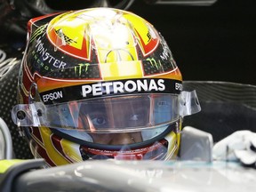 Mercedes driver Lewis Hamilton, of Britain, sits in his car during the first practice session for the Formula One U.S. Grand Prix auto race at the Circuit of the Americas, Friday, Oct. 20, 2017, in Austin, Texas. (AP Photo/Tony Gutierrez)