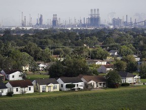 A residential neighborhood sits next to an oil refinery in Port Arthur, Texas, Thursday, Sept. 28, 2017. The region's economy is tied to the petroleum industry more than in any other place in America: the concentration of people here employed by refineries is 81 times higher than the rest of the country. Though research suggests most in Jefferson County believe that humans have contributed to the warming of the globe, many struggle still to know what to expect their leaders to do about it without at the same time crippling their own economy. (AP Photo/David Goldman)