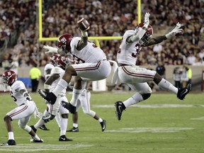 Alabama's Raekwon Davis (99) celebrates with Rashaan Evans (32) after recovering a fumble against Texas A&M during the second quarter of an NCAA college football game Saturday, Oct. 7, 2017, in College Station, Texas. (AP Photo/David J. Phillip)