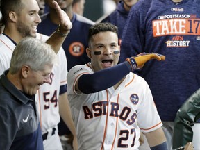 Houston Astros' Jose Altuve (27) celebrates his home run with teammates during the first inning in Game 1 of baseball's American League Division Series against the Boston Red Sox, Thursday, Oct. 5, 2017, in Houston. (AP Photo/David J. Phillip)