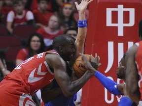 Houston Rockets forward Tarik Black (28) finds the going tough against Dallas Mavericks Jose Juan Barea, center, and Nerlens Noel, right, in the first half of an NBA basketball game Saturday, Oct. 21, 2017, in Houston. (AP Photo/George Bridges) 5 l 3 r