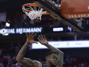 Memphis Grizzlies forward Jarell Martin (1) finishes off a dunk against the Houston Rockets in the first half of an NBA basketball game, Monday, Oct. 23, 2017, in Houston. (AP Photo/George Bridges)
