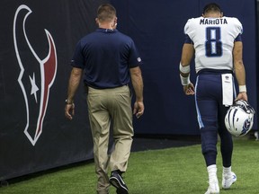 Tennessee Titans quarterback Marcus Mariota (8) walks off the field after suffering a hamstring injury during the third quarter of an NFL football game against the Houston Texans at NRG Stadium on Sunday, Oct. 1, 2017, in Houston. (Brett Coomer/Houston Chronicle via AP)