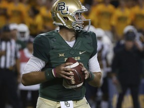 Baylor quarterback Zach Smith (8) drops back to pass against West Virginia in the first half of an NCAA college football game, Saturday, Oct. 21, 2017, in Waco, Texas. (AP Photo/Jerry Larson)