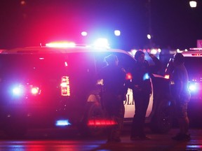 Emergency personnel stage at an intersection across from Talkington Hall on the Texas Tech University campus  in Lubbock, Texas, Monday, Oct. 9, 2017. Police apprehended a 19-year-old student accused of fatally shooting a Texas Tech University police officer at the campus police station Monday night. (Mark Rogers/Lubbock Avalanche-Journal via AP)