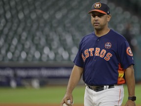Houston Astros bench coach Alex Cora watches batting practice before Game 6 of the American League Championship Series baseball game against the New York Yankees Friday, Oct. 20, 2017, in Houston. (AP Photo/David J. Phillip)