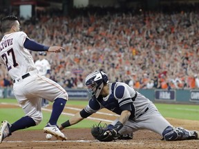 Houston Astros' Jose Altuve scores the game-winning run past New York Yankees catcher Gary Sanchez during the ninth inning of Game 2 of baseball's American League Championship Series Saturday, Oct. 14, 2017, in Houston. The Astros won 2-1 to take a 2-0 lead in the series. (AP Photo/David J. Phillip)