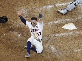 Houston Astros' Jose Altuve scores the game-winning run past New York Yankees catcher Gary Sanchez during the ninth inning of Game 2 of baseball's American League Championship Series Saturday, Oct. 14, 2017, in Houston. The Astros won 2-1 to take a 2-0 lead in the series. (AP Photo/David J. Phillip)