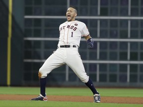 Houston Astros' Carlos Correa celebrates after hitting a double that scored the game-winning run during the ninth inning of Game 2 of baseball's American League Championship Series against the New York Yankees Saturday, Oct. 14, 2017, in Houston. The Astros won 2-1 to take a 2-0 lead in the series. (AP Photo/David J. Phillip)