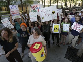 Member of the Texas Campaign for the Environment prepare to deliver over 2,300 letters from Texas families to the Environmental Protection Agency's Region VI office in Dallas, Thursday, Oct. 12, 2017. The letters are calling for saving federal cleanup programs under the Trump Administration. The EPA has approved a plan to remove sediments laced with highly toxic dioxin from a partially submerged Superfund site near Houston damaged during Hurricane Harvey. (AP Photo/LM Otero)