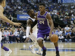 Sacramento Kings guard Buddy Hield (24) dribbles against Dallas Mavericks guard Wesley Matthews, rear, during the first half of an NBA basketball game in Dallas, Friday, Oct. 20, 2017. (AP Photo/LM Otero)