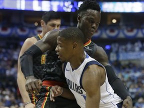 Dallas Mavericks guard Dennis Smith Jr. (1) drives against Atlanta Hawks guard Dennis Schroder (17) of Germany during the first half of an NBA basketball game in Dallas, Wednesday, Oct. 18, 2017. (AP Photo/LM Otero)