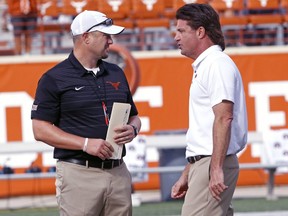 Texas head coach Tom Herman, left, talks with Oklahoma State head coach Mike Gundy, right, before the start of an NCAA college football game, Saturday, Oct. 21, 2017, in Austin, Texas. (AP Photo/Michael Thomas)
