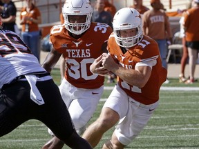 Texas quarterback Sam Ehlinger (11) runs the ball during the first half of an NCAA college football game against Oklahoma State, Saturday, Oct. 21, 2017, in Austin, Texas. (AP Photo/Michael Thomas)
