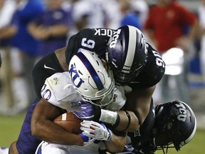 TCU defensive tackle Ross Blacklock (90) takes down Kansas running back Khalil Herbert (10) during the first half of an NCAA college football game Saturday, Oct. 21, 2017, in Fort Worth, Texas. (AP Photo/Ron Jenkins)