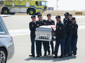 FILE - In this Oct. 13, 2017, photo, soldiers carry the casket of Spc. Alex Missildine from the tarmac at Tyler Pounds Regional Airport in Tyler, Texas. (Cory McCoy/Tyler Morning Telegraph via AP)