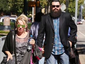 Jacob Carrizal, right, the first biker to be prosecuted for his alleged role in the May 17, 2015, Twin Peaks shootout heads to court with an unidentified woman, Wednesday Oct. 11, 2017, in Waco, Texas.  Jury selection began this week in the first of those trials, against Bandidos Dallas chapter president Christopher "Jake" Carrizal for leading and engaging in organized criminal activity. (Rod Aydelotte/Waco Tribune Herald via AP)