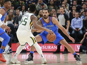 Oklahoma City Thunder center Steven Adams (12) guards Utah Jazz guard Donovan Mitchell (45) during the first quarter of an NBA basketball game Saturday, Oct. 21, 2017, in Salt Lake City. (AP Photo/Chris Nicoll)