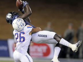 Boise State cornerback Avery Williams (26) breaks up a pass intended for Utah State wide receiver Ron'quavion Tarver (1) during an NCAA football game, Saturday, Oct. 28, 2017, in Logan, Utah. (Eli Lucero/Herald Journal via AP)/The Herald Journal via AP)